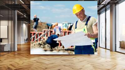 engineer builders at construction site with draft Wall mural