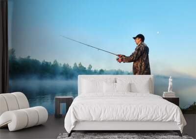 fisher fishing on foggy sunrise Wall mural