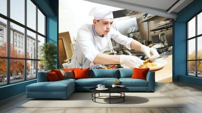 male cook chef decorating food on the plate Wall mural