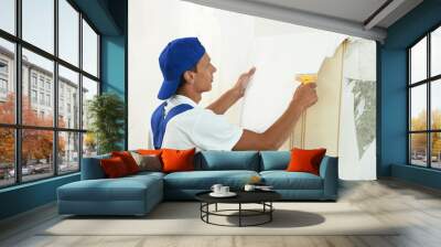 painter worker peeling off wallpaper Wall mural