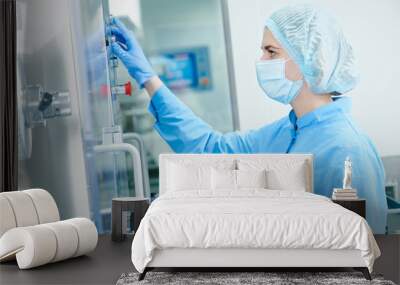 pharmaceutics. pharmaceutical worker operates blister packaging machine Wall mural