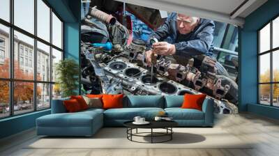 Truck repair service. Serviceman measuring cylinder Wall mural