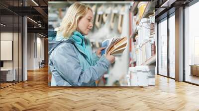 woman selecting paint at hardware store Wall mural