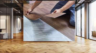 worker joining vinyl floor covering at home renovation Wall mural