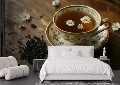 A cup of herbal tea with chamomile flowers on the saucer, sitting in an elegant teacup Wall mural