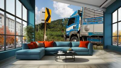 Signpost bends and trucks. Wall mural