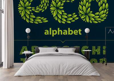 Alphabet logos formed by fresh green leaves. Wall mural