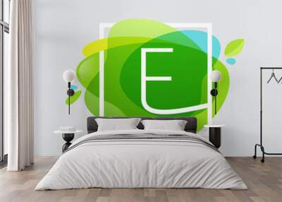 E letter logo in square frame at green watercolor splash backgro Wall mural