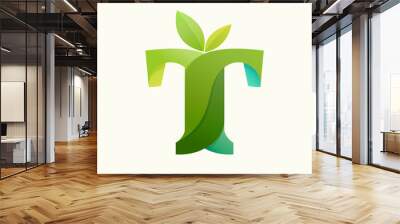 Swirling letter T logo with green leaves. Wall mural