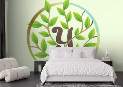 Y letter logo made of twisted tree branches and green leaves in circle. Wall mural