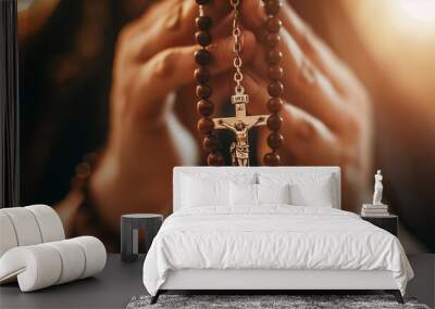 Close-up of a hand holding a rosary, with softly lit background highlighting devotion.
 Wall mural