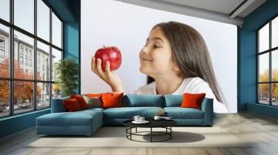 Happy cute child girl eating fresh apples. Vitamins and healthy nutrition. Beautiful face. Healthy teeth. Wall mural