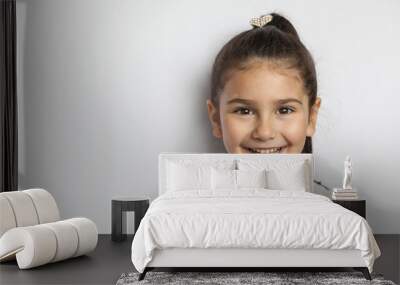 Portrait of happy cute brunette child  girl on white background Wall mural