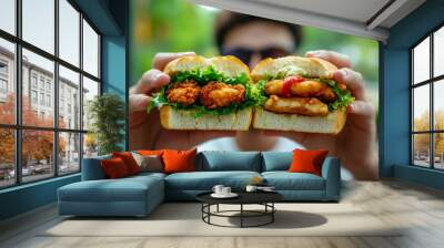 Close-Up of Hands Holding Tasty Chicken Sandwiches Outdoors Wall mural