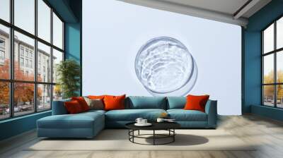 Petri dish with water and ripple in blue background Wall mural