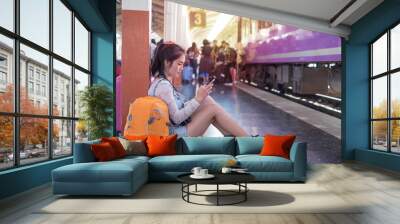 woman travel with train station and mobile Wall mural