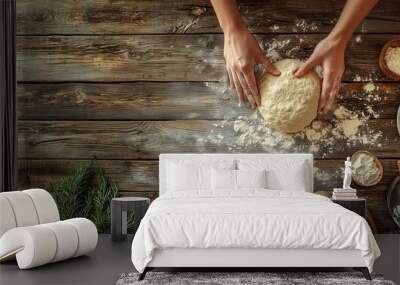 Hands kneading dough on a rustic wooden table surrounded by flour and ingredients, symbolizing homemade baking and traditional cooking. Wall mural