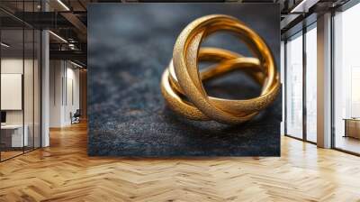 Intertwined Gold Rings Symbolizing Love and Commitment Wall mural