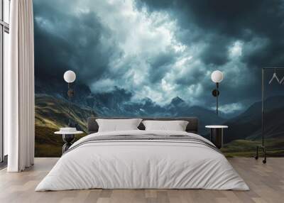 A dramatic sky over a mountainous landscape with heavy, dark clouds threatening rain. The imposing clouds and rugged peaks create a powerful and awe-inspiring natural scene. Wall mural