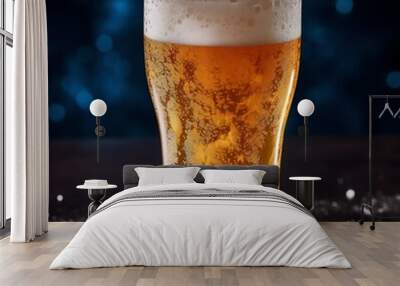 A glass of cold fresh beer with cap of foam. Splash of foam with tasty american beer. Beer day Wall mural