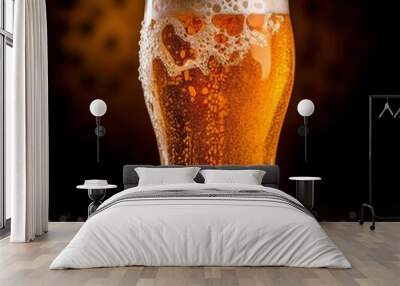 A glass of cold fresh beer with cap of foam. Splash of foam with tasty american beer. Beer day Wall mural