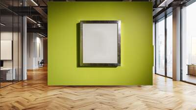 Blank silver color picture frame template for place image inside on the yellow green wall. Wall mural