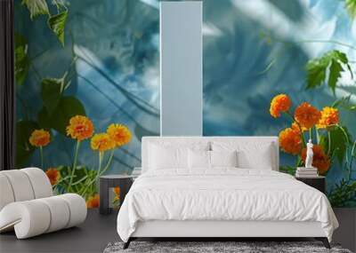 A minimalistic product display featuring a white rectangular pedestal surrounded by vibrant orange flowers, green leaves, and fresh blueberries against a blue artistic background Wall mural