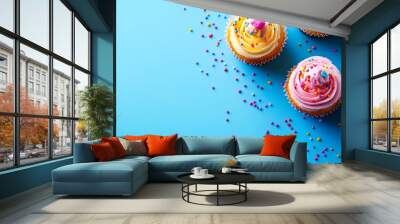 Colorful cupcakes with sprinkles on a bright blue background great for birthday, celebration, or dessert-themed projects, Can be used in party invitations, recipes Wall mural