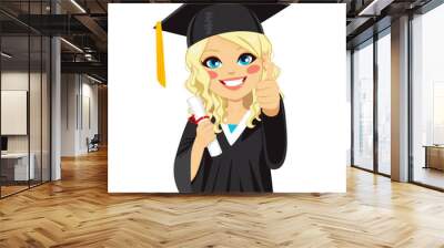 Beautiful blonde girl on graduation day with diploma and making thumbs up hand sign Wall mural