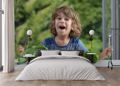 cute little boy sitting at the table excited about vegetable meal, bad or good eating habits, nutrit Wall mural