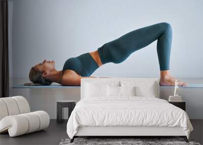 Adult woman practising yoga at home Wall mural