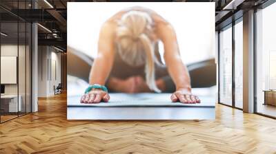 Adult woman practising yoga at home Wall mural