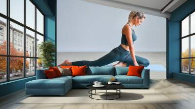 Adult woman practising yoga at home Wall mural