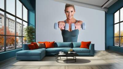 Adult woman working out with dumbells Wall mural