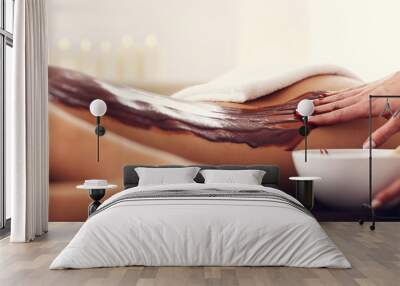 Beautiful woman getting chocolate massage in spa Wall mural