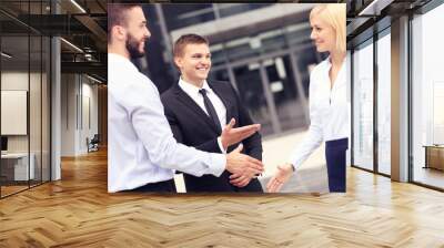 Business people greeting outside modern building Wall mural