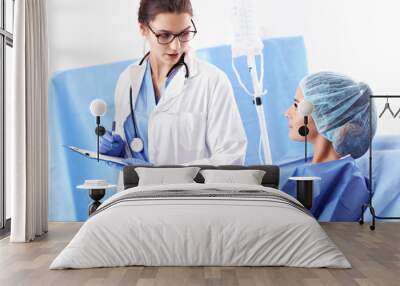 Female doctor taking care of patient in hospital Wall mural