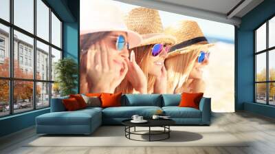 Group of friends sunbathing on the beach Wall mural