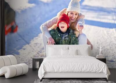 Nice happy family having fun on winter snow Wall mural