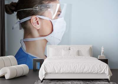 Portrait of female medical doctor wearing protective mask and face shield Wall mural