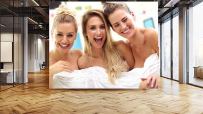 Three beautiful young women in home spa Wall mural