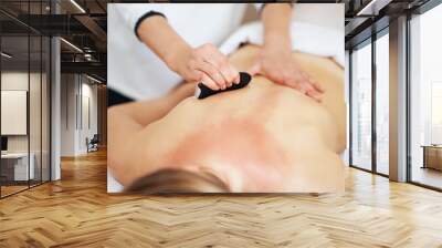 Woman having a gua sha massage in salon Wall mural