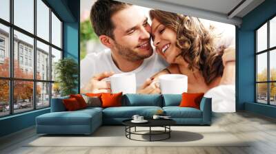 Young couple drinking coffee in bed Wall mural