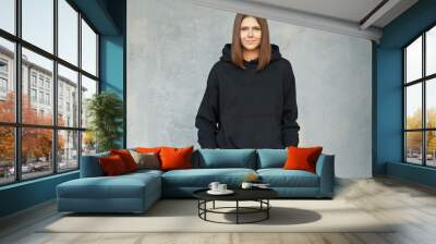 young woman in black hoodie. Wall mural