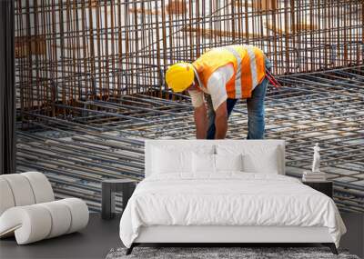 Construction worker installing floor slab reinforcement bars Wall mural