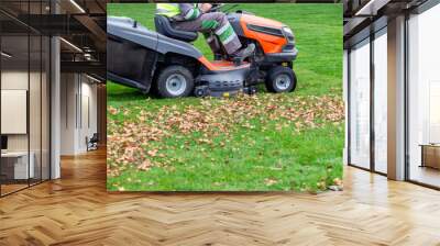 Tractor mower in motion, cutting the lawn Wall mural