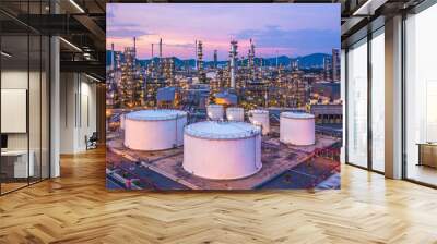 Aerial view oil and gas chemical tank with oil refinery plant background at twilight, business power and energy chemical barrel. Wall mural