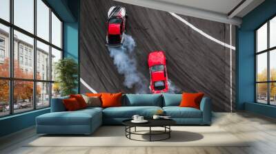 Aerial view two cars drift battle view from above, Activity two cars drift action battle on asphalt race track with abstract smoke. Wall mural