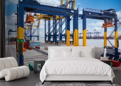 Industrial container yard with crane for business logistic import export, Crane loading cargo container to container ship in the international terminal yard container depot sea port freight shipping. Wall mural