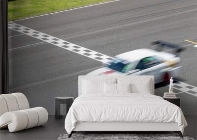 Motion blur race car racing on speed track, Car race on the international circuit race track crossing start and finish line, Race car crossing start and finish line, Target business achieve victory. Wall mural